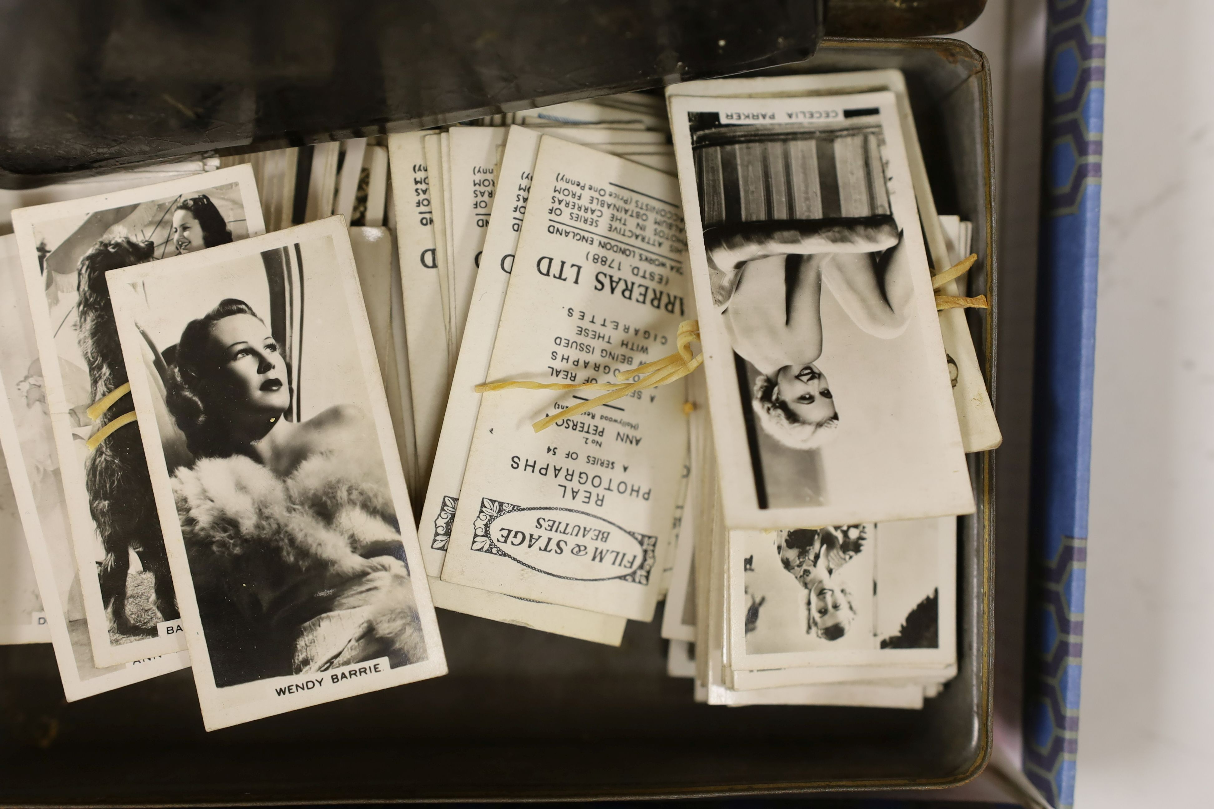 A Victorian walnut stereoscopic viewer and slides, a tinplate viewer, cigarette cards, Glamour Girls, etc.